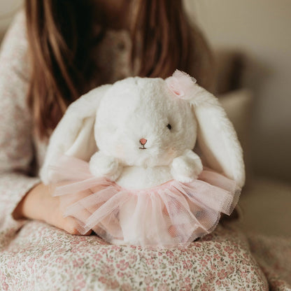 Blossom Bunny with pink tutu held in a child’s arms