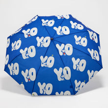 Blue umbrella with white 'YO' pattern on a light gray background