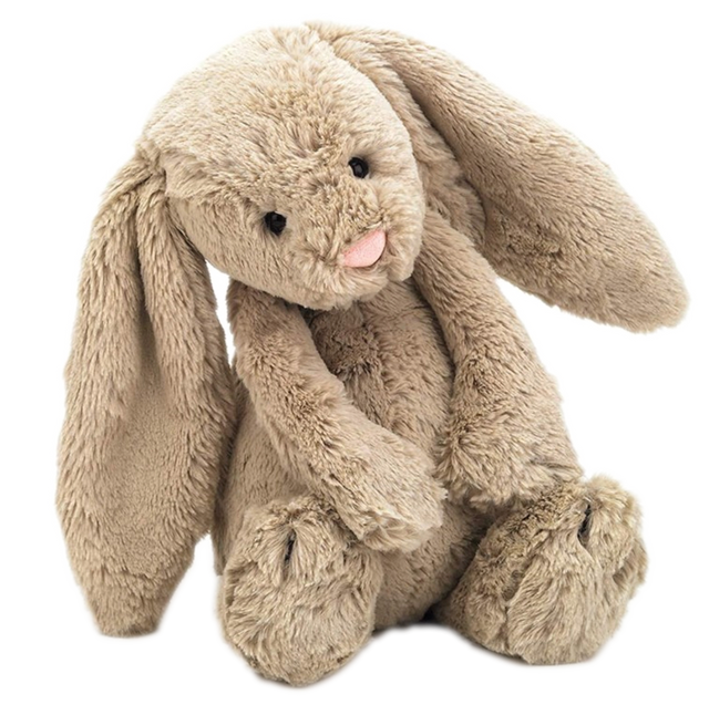 A plush long-eared bunny stuffed animal in a warm beige/tan color, sitting against a plain white background.