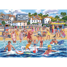 A colorful beach scene illustration showing people swimming, playing, and walking on the sand with houses, trees, and a seaside food stall in the background.