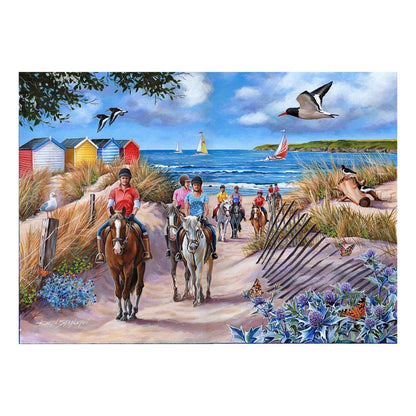 People riding horses on a beach with colorful huts and ocean view