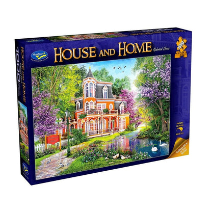 Jigsaw puzzle box featuring a scenic house with trees and water, branded 'House and Home'.