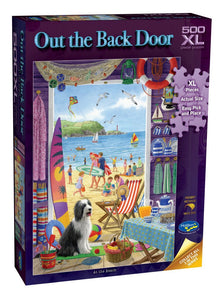 A 500-piece jigsaw puzzle box titled 'Out the Back Door' by Castle Builders. The box features a colorful illustration of a beach scene viewed from inside a house, with a black and white dog in the foreground.