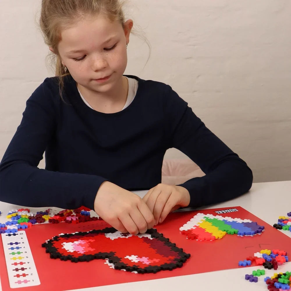 Both finished heart mosaics from the set shown side by side in red, pink and coral