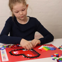 Both finished heart mosaics from the set shown side by side in red, pink and coral