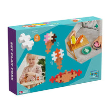 Fifty chunky Plus-Plus BIG pieces laid out beside the illustrated food idea booklet