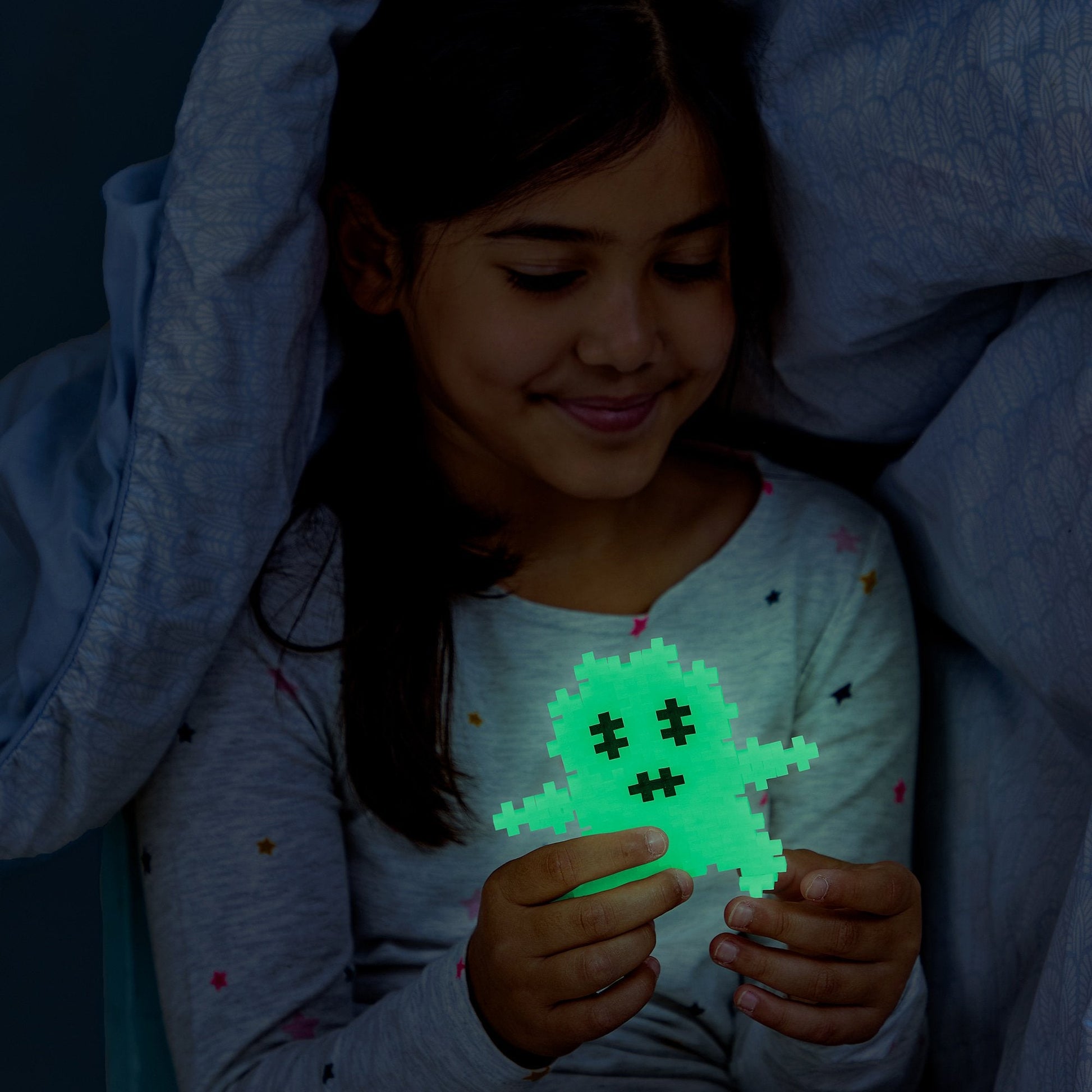 Neon Plus-Plus creation built from the 240 piece glow mix, shown under dark room.