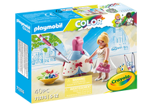 Playmobil Color 71374 Barbie dressmaker set box, featuring a blonde female figure in a white dress with a pink purse, a pink and blue dress form, paintbrushes, and a bowl of colorful paint tubes on the front of the retail packaging.