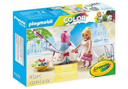 Playmobil Color 71374 Barbie dressmaker set box, featuring a blonde female figure in a white dress with a pink purse, a pink and blue dress form, paintbrushes, and a bowl of colorful paint tubes on the front of the retail packaging.