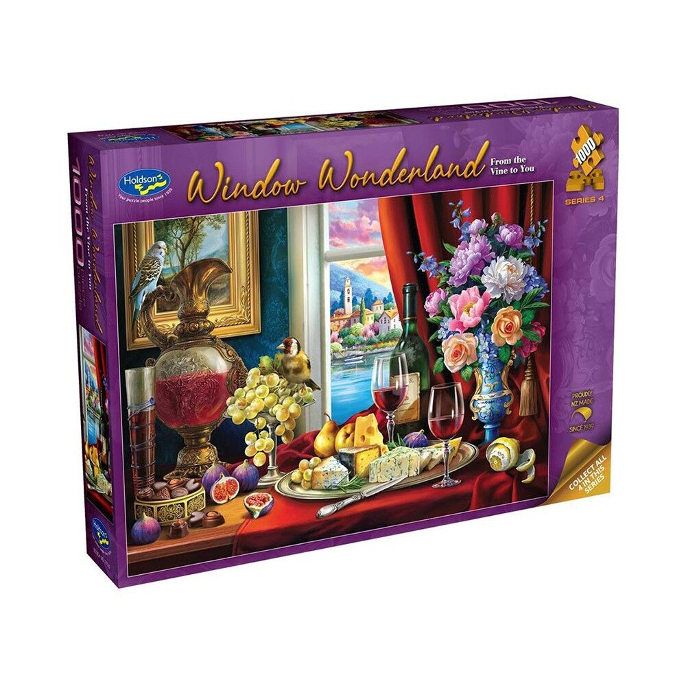 A boxed jigsaw puzzle package titled "Window Wonderland" by Hadley, shown at a slight angle on a plain white background. The box is predominantly purple with a large colorful illustration of a table scene featuring flowers, wine glasses, fruit, and a scenic window view.
