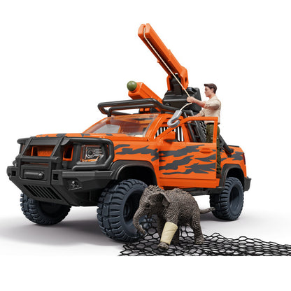 Schleich orange and black toy off-road rescue truck with a crane, shown with a small injured elephant figurine and net. A small human figure is seated in the driver's seat.