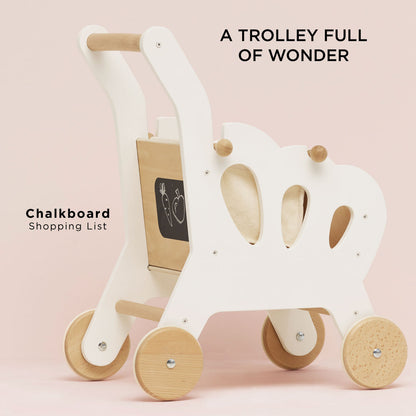 Children's wooden trolley with a chalkboard on a pink background