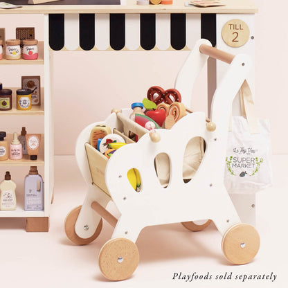 Children's toy shopping cart with playfood items and a 'Supermarket' bag in a pretend store setting.