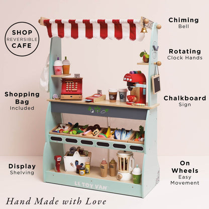 Le Toy Van Shop & Café Market Stand showing its reversible shop and café design, chiming bell, rotating clock hands, chalkboard sign, shopping bag and display shelving, styled with pretend food and café accessories sold separately.