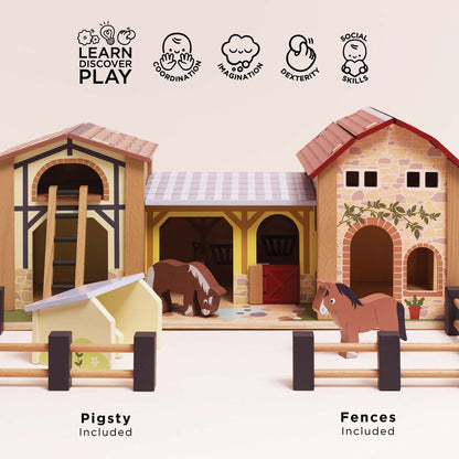 Front view of Le Toy Van Wooden Farmyard Set featuring the included pigsty, movable wooden fences, two horses, stable buildings and hay loft ladder, encouraging imaginative farm play.