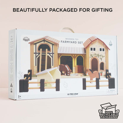Le Toy Van Wooden Farmyard Set retail packaging featuring an illustration of the wooden farm buildings, horses, pigsty and fences, with carry handle and recyclable packaging. Suitable for ages 3 years and over.