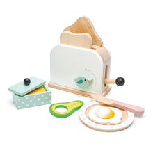Toy toaster set with avocado, egg, and toast on a white background