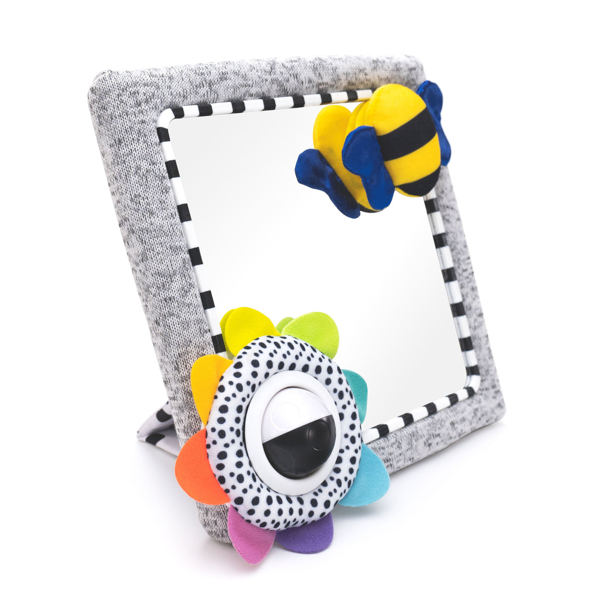 Baby tummy time activity mirror with grey fabric frame, colourful flower spinning ball, yellow and blue plush bee and black and white striped border.