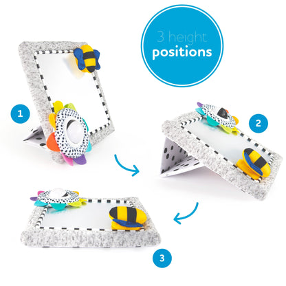 Baby tummy time activity mirror showing three adjustable height positions, from upright to flat, with colourful sensory toys and a foldable stand.