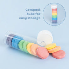 Close-up of a single bath fizzer tablet showing its round shape and striped surface pattern