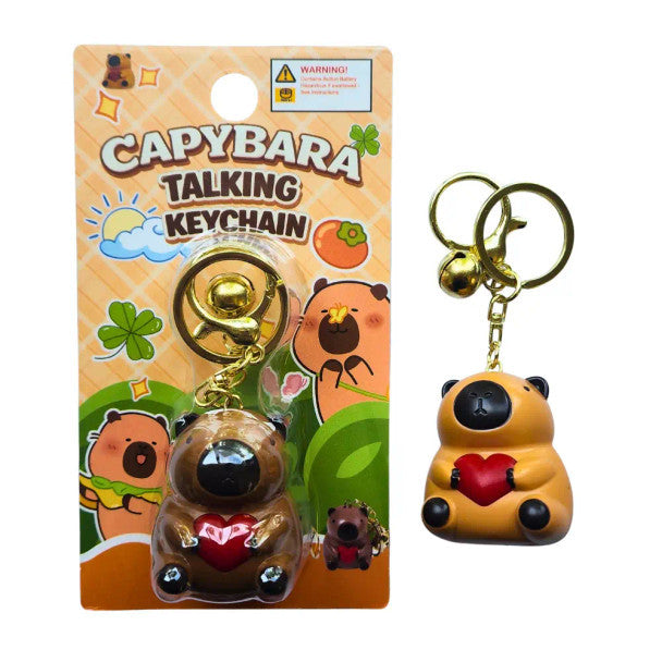 Cute capybara talking keychain holding a red heart with gold keyring accessory and collectible animal toy packaging.