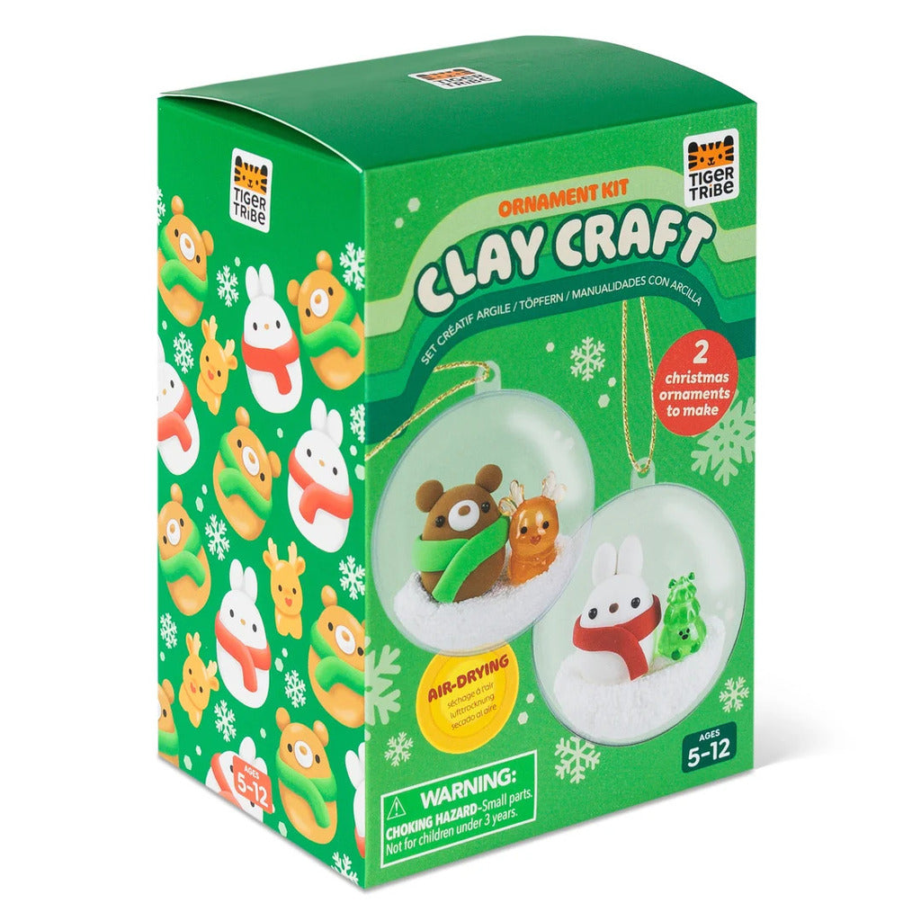 Child's hands shaping the coloured clay into an ornament while following the visual guide