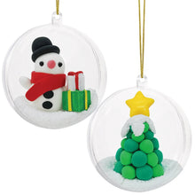 The finished snowman and Christmas tree clay ornaments hung together on a tree branch