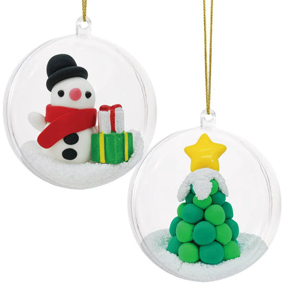 The finished snowman and Christmas tree clay ornaments hung together on a tree branch