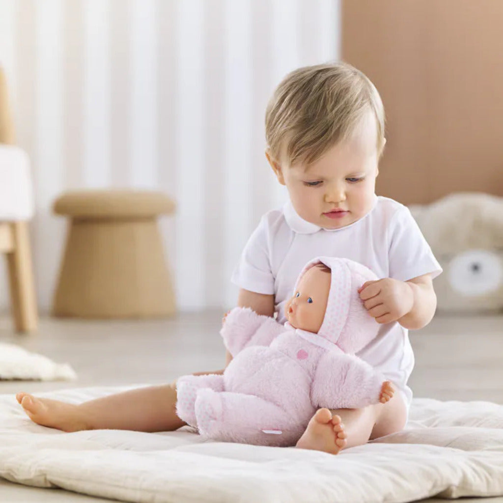Parent and newborn cuddling the Corolle Babibear comforter doll during a calm bedtime routine