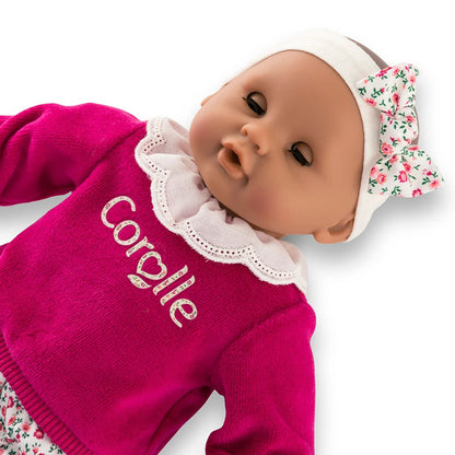 Bebe Calin Maria lying on her back with her sleeping eyes closed, showing the flexible fabric body