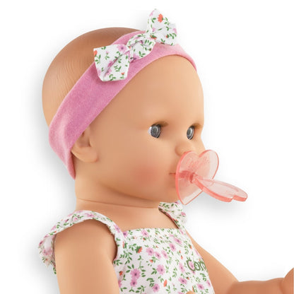 Corolle Emma baby doll close up showing dummy in her mouth and soft vinyl face