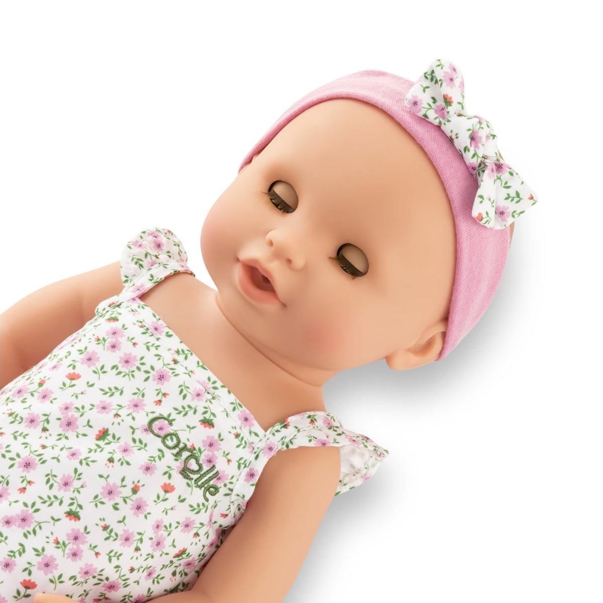 Corolle Emma baby doll close up showing sleeping eyes and soft vinyl face