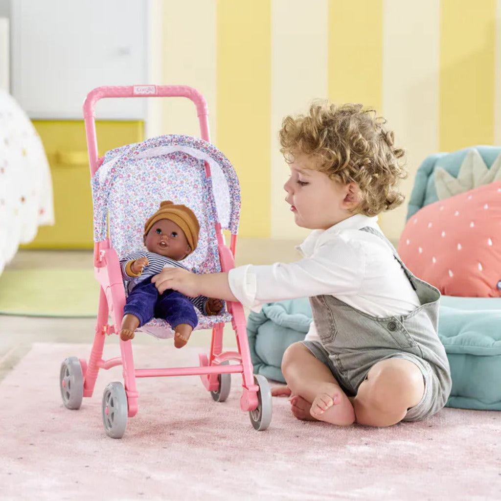 Close-up of the pink floral fabric seat and canopy on the Corolle flowered doll stroller