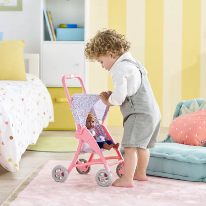 30cm Corolle baby doll sitting securely in the fabric seat of the flowered doll stroller