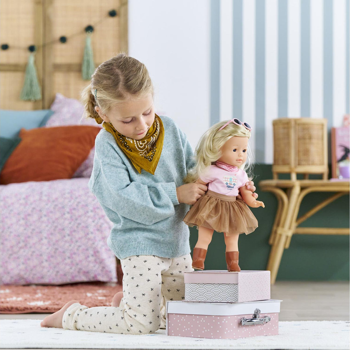 Child playing with a Ma Corolle doll wearing the Festival Outfit Set