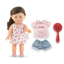 Romy Mini World accessories laid out: a change of clothing and a hairbrush for styling her hair