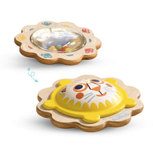 An adorable wooden rattle. One side features a lovely flower and on the other a sweet lion's face.