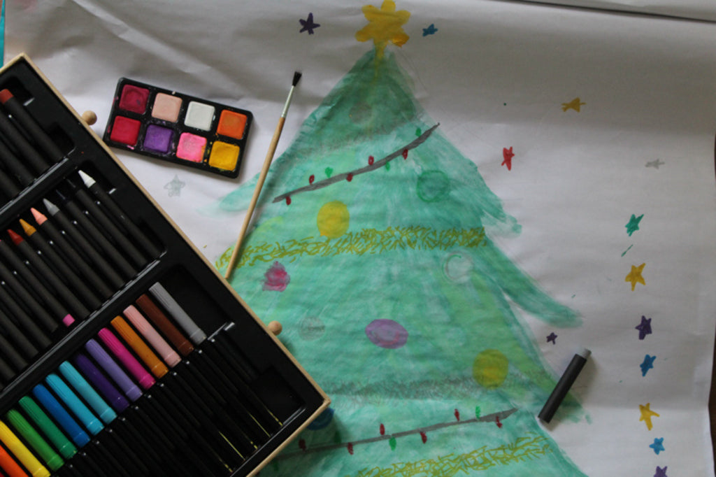 Child colouring with pencils from the Djeco Big Box of Colours during creative play