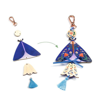 Close-up of a decorated butterfly charm from the Djeco DIY kit showing its colourful wings and details