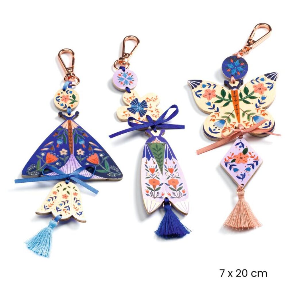 Butterfly charm made with the Djeco kit hanging from a backpack zip as a handmade friendship gift