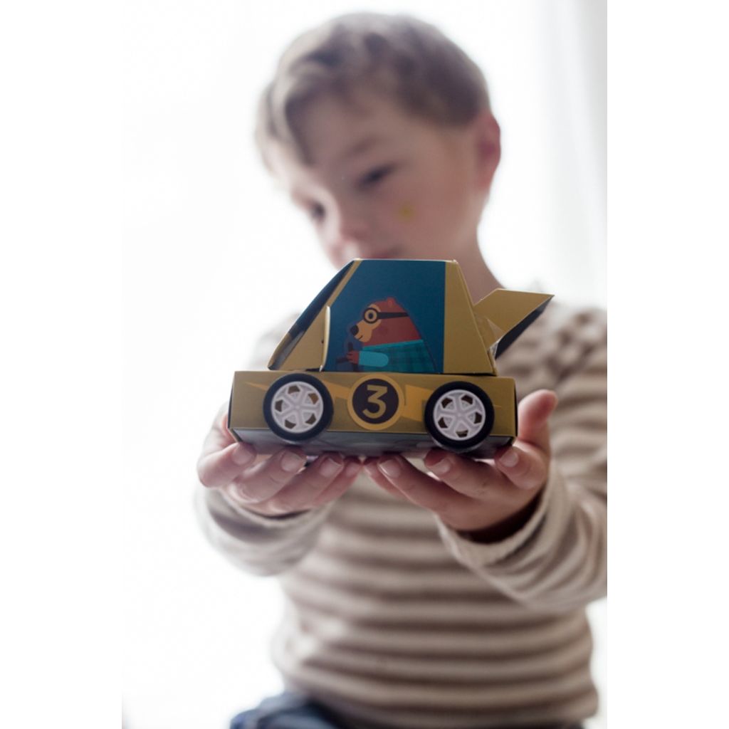 Line-up of finished Djeco Grand Prix racing cars on a pretend starting grid, ready for a race
