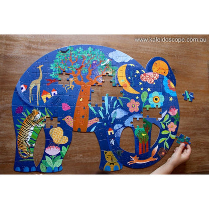 Loose pieces of the Djeco 150 piece elephant art puzzle spread out on a table before assembly begins