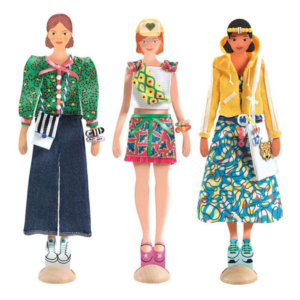 Three finished dolls on wooden bases wearing completed fabric outfits and trims