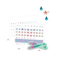 The full contents laid out: glitter sticker sheets, rhinestones and two mermaid nail files