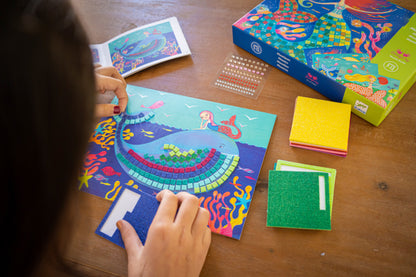 Full contents of the Djeco Mermaid's Song mosaic kit laid out: boards, foam sheets and booklet