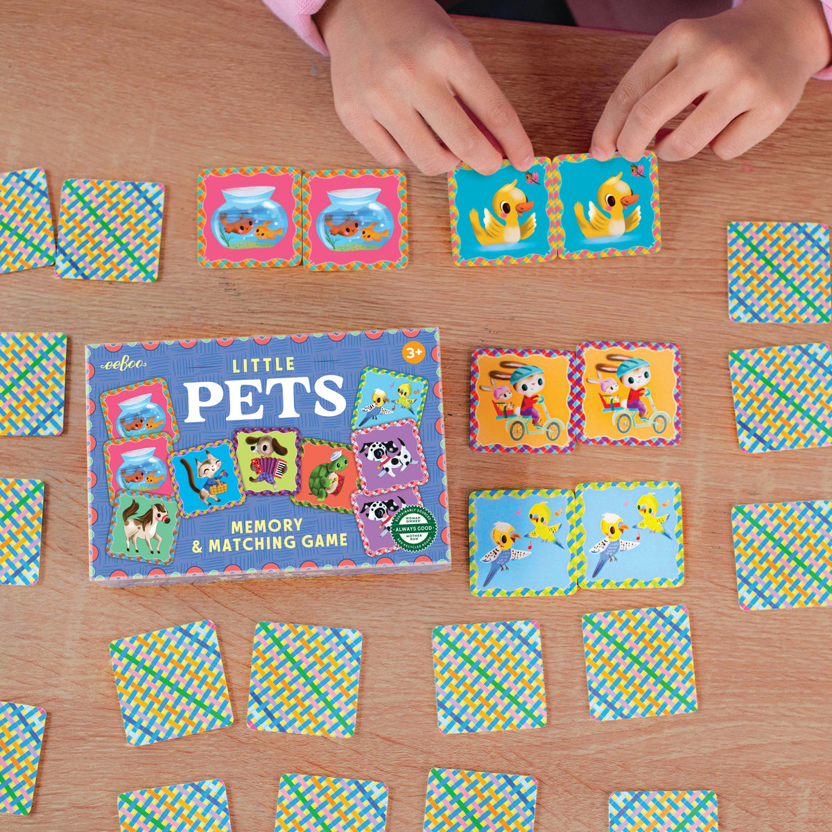 Close-up of eeBoo Little Pets Memory & Matching Game showing matching pairs of illustrated fish, ducks, birds and rabbits on colourful cards.