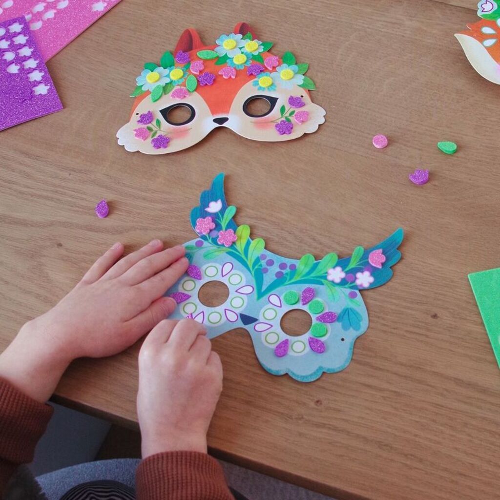 all eight completed forest animal masks laid out side by side after being decorated
