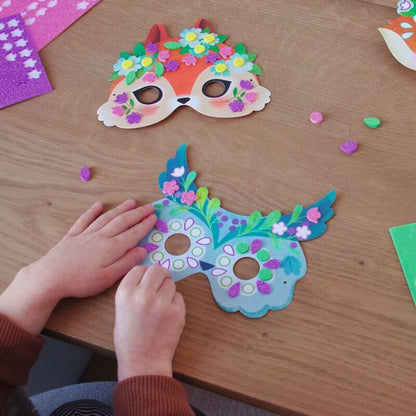 all eight completed forest animal masks laid out side by side after being decorated