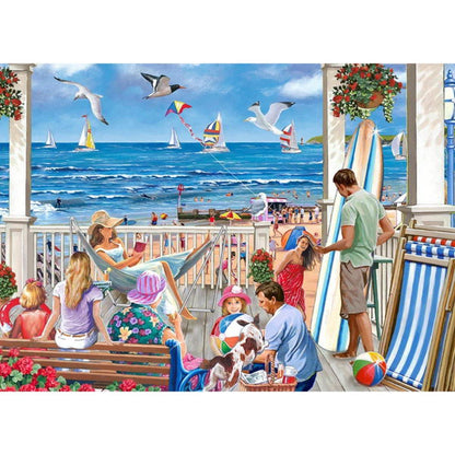 People enjoying a day at the beach with a view of the ocean and seagulls.