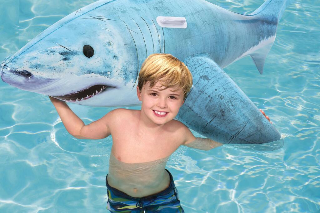 Kids playing on the large Bestway inflatable shark pool float at a backyard pool party